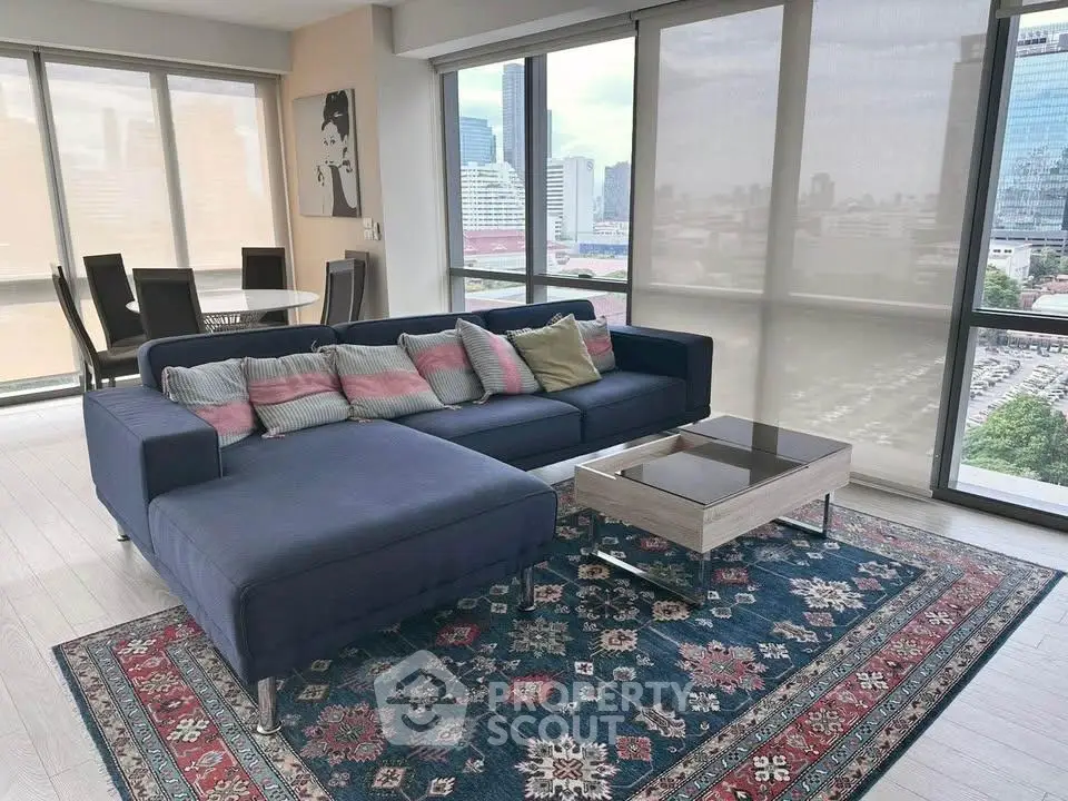 Spacious living room with modern sofa and city view, perfect for urban living.