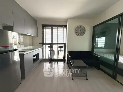 Modern open-layout living room with sleek kitchen and stylish decor
