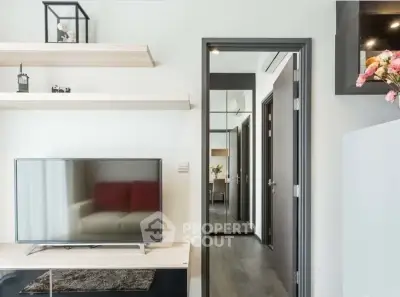 Modern living room with sleek TV setup and stylish shelving