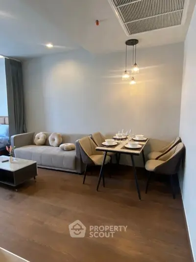 Modern living room with cozy dining area and stylish furniture in open layout apartment.