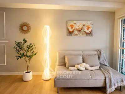 Cozy living room with modern sofa, stylish lamp, and elegant decor accents.
