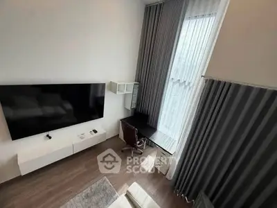 Modern living room with high ceilings, large TV, and stylish furniture