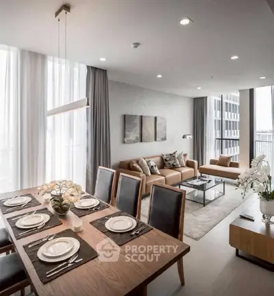 Luxurious open-plan living and dining area with elegant decor and natural light.