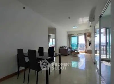 Spacious living room with dining area and balcony view in modern apartment