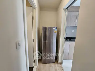 Modern kitchen with stainless steel fridge and sleek cabinetry