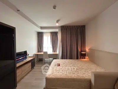 Spacious bedroom with modern decor and natural light