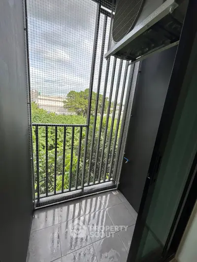 Compact balcony with greenery view and modern railing design