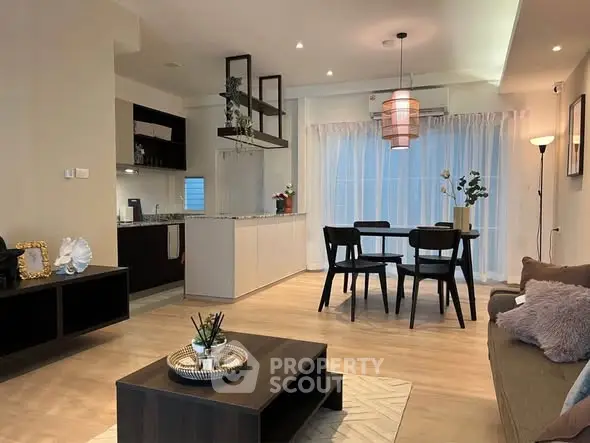 Modern open-plan living room with stylish dining area and contemporary kitchen design.