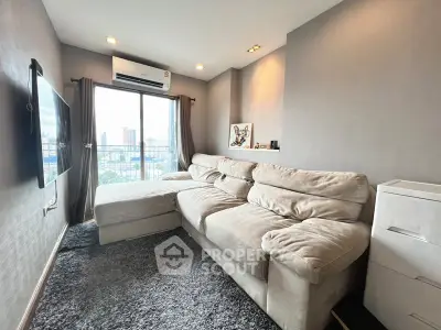 Modern living room with plush sofa and city view from large window