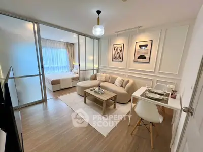 Modern open-plan living room with elegant decor and cozy bedroom view