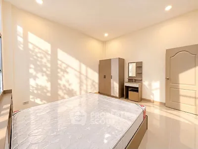 Bright and spacious bedroom with modern furniture and natural light.