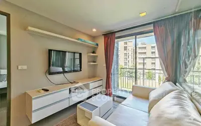Modern living room with large window and stylish furniture in a bright apartment.