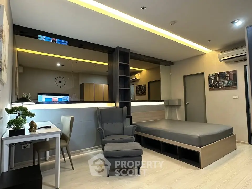 Modern studio apartment with stylish decor and cozy furnishings, featuring a comfortable bed and elegant lighting.