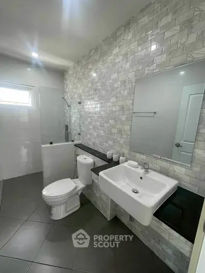 Modern bathroom with sleek design and elegant tile work.