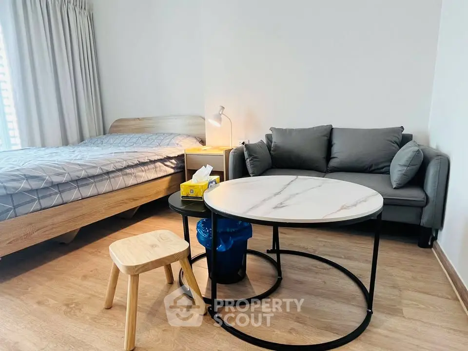 Modern bedroom with cozy seating area and stylish decor