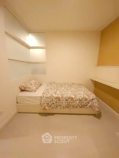 Cozy bedroom with modern design and floral bedding in a stylish apartment.