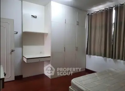 Spacious bedroom with built-in wardrobe and natural light