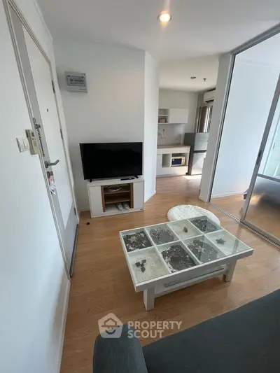 Modern living room with stylish decor and open kitchen layout in a cozy apartment.