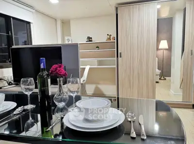 Modern dining area with elegant table setting and cozy living space