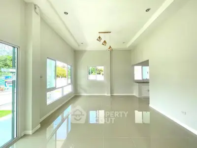 Spacious modern living room with high ceilings and large windows