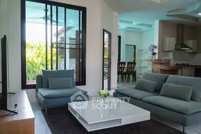 Modern living room with stylish furniture and open kitchen layout