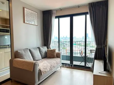 Modern living room with city view and balcony access in stylish apartment.
