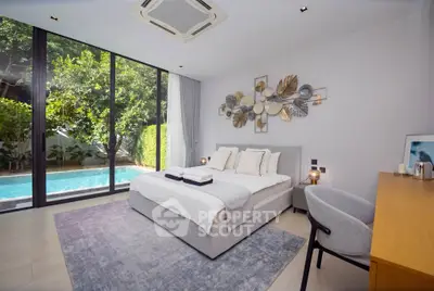 Luxurious bedroom with pool view, modern decor, and large windows in a serene setting.