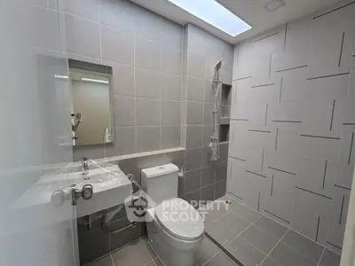 Modern bathroom with sleek gray tiles and contemporary fixtures