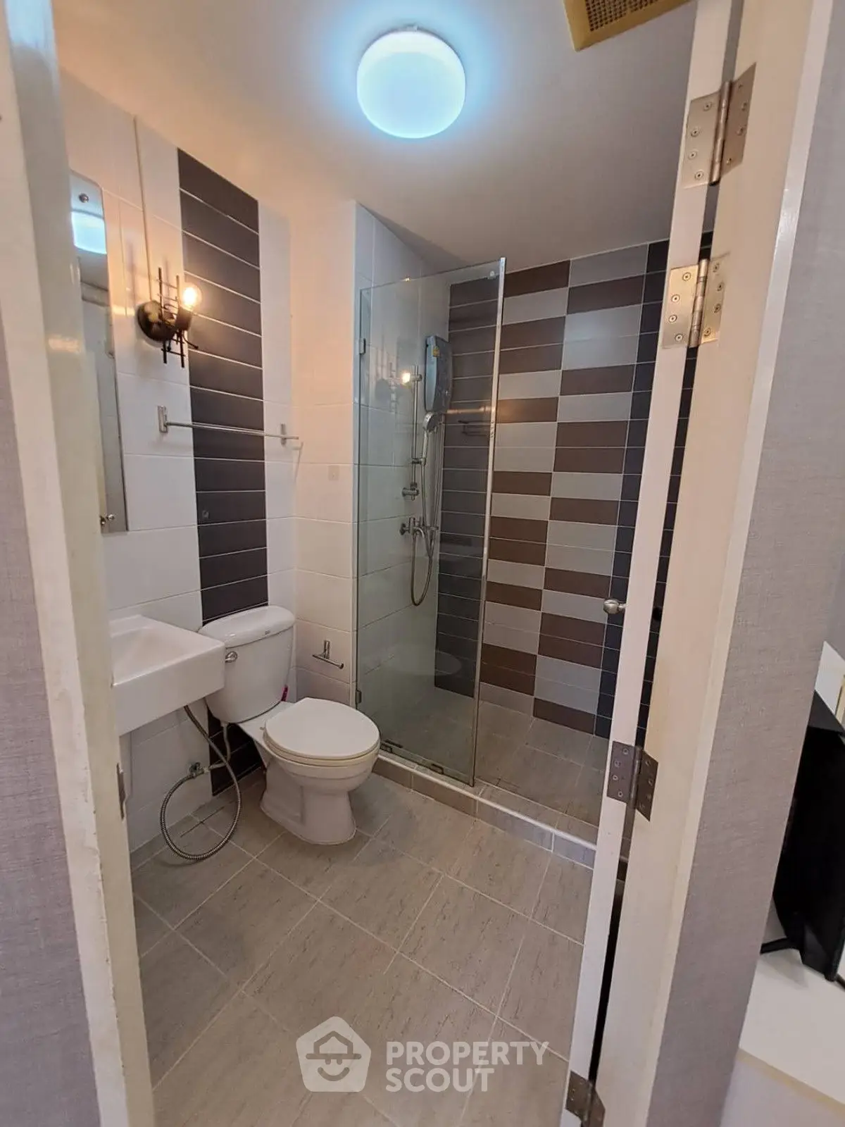 Modern bathroom with glass shower and stylish tile design