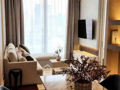 Modern living room with large windows and city view, featuring stylish decor and a wall-mounted TV.