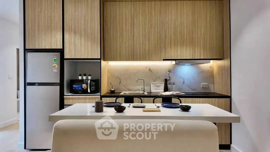 Modern kitchen with sleek cabinetry and integrated appliances in a stylish apartment.