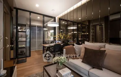 Modern living room with elegant decor and open dining area, featuring stylish lighting and cozy seating.