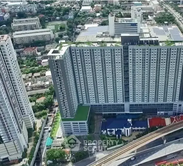 Aerial view of modern high-rise residential building in urban area.