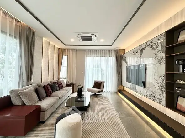 Luxurious modern living room with elegant decor and large windows.