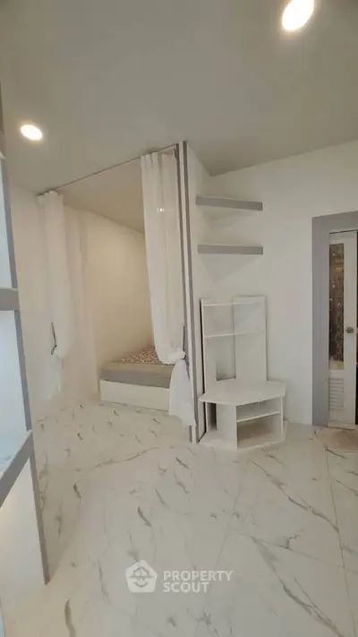 Modern minimalist bedroom with marble flooring and cozy bed nook