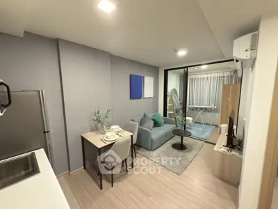 Modern open-plan living room with stylish decor and compact dining area in a cozy apartment.