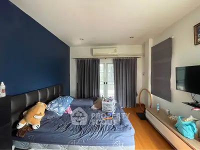 Cozy bedroom with blue accent wall and modern furnishings