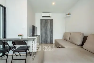 Modern living room with cozy sofa and sleek TV setup, perfect for relaxation.