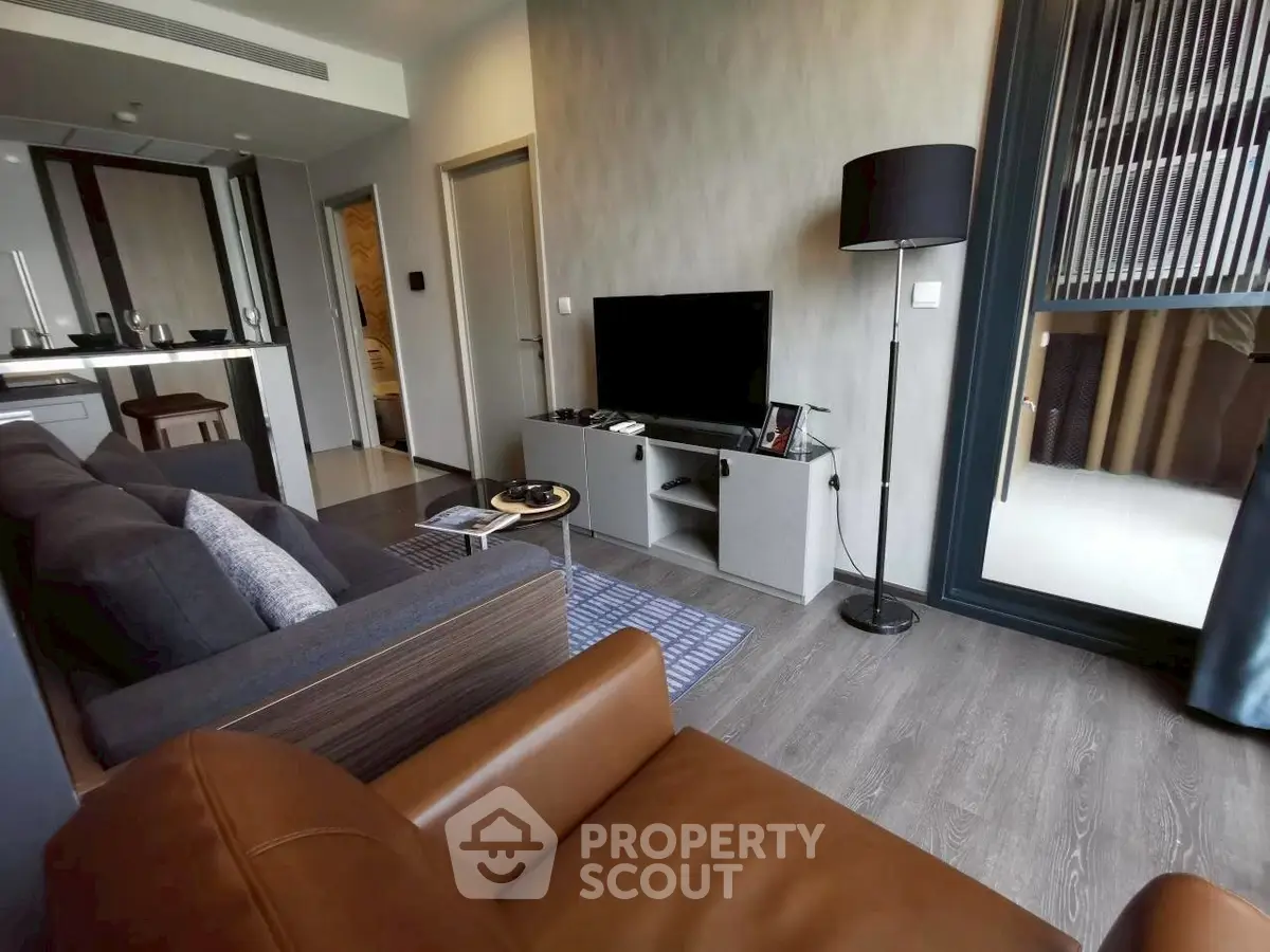 Modern living room with stylish furniture and open kitchen layout