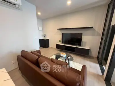 Modern living room with sleek furniture and entertainment center, perfect for relaxation and entertainment.