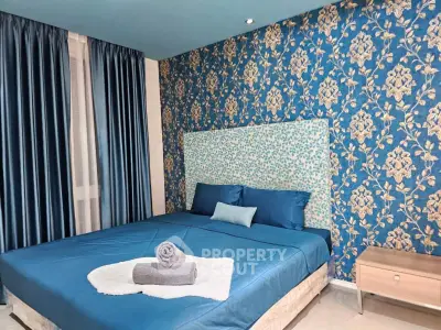 Luxurious bedroom with elegant blue floral wallpaper and plush bedding