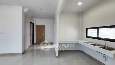 Spacious modern kitchen with sleek countertops and ample natural light.