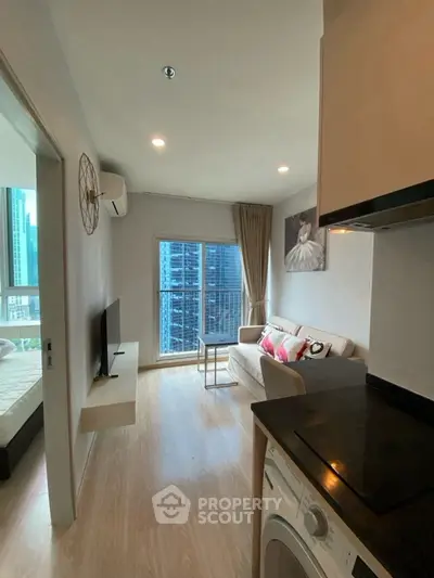 Modern living room with city view, cozy sofa, and stylish decor in a high-rise apartment.