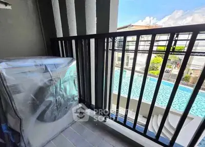 Charming balcony with pool view, perfect for relaxation and leisure in a modern residential setting.
