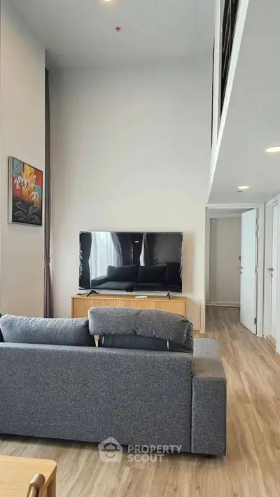 Modern living room with high ceiling and stylish decor