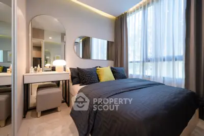 Modern bedroom with stylish decor and large windows offering natural light
