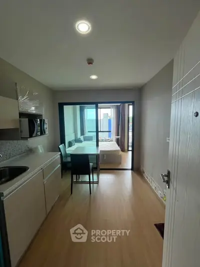 Modern studio apartment with open kitchen and cozy bedroom area