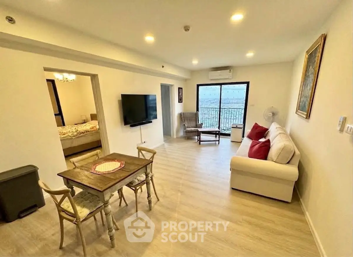 Spacious living room with modern decor and balcony view