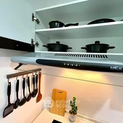 Modern kitchen with sleek stove, open shelving, and stylish utensils for a contemporary cooking space.