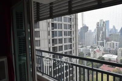 Spacious balcony with stunning city skyline view in modern high-rise apartment.